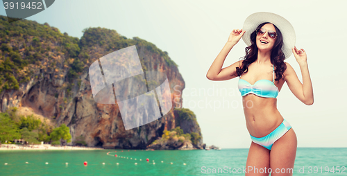 Image of happy young woman in bikini swimsuit and sun hat