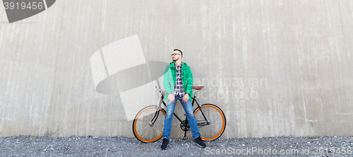 Image of happy young hipster man with fixed gear bike