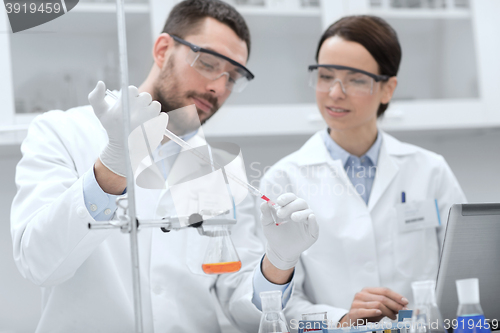 Image of young scientists making test or research in lab