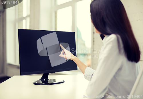 Image of close up of woman with computer monitor in office