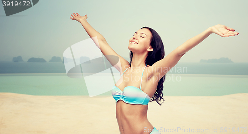 Image of happy woman in bikini swimsuit with raised hands