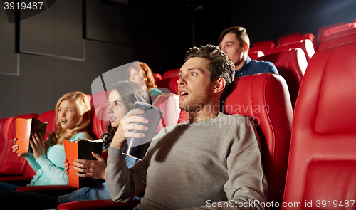 Image of friends watching horror movie in theater