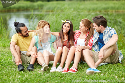 Image of group of smiling friends talking outdoors