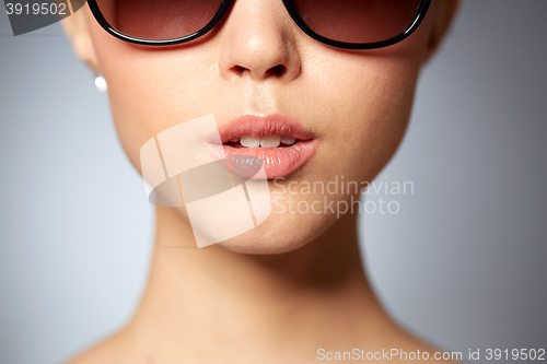 Image of close up of beautiful woman in black sunglasses