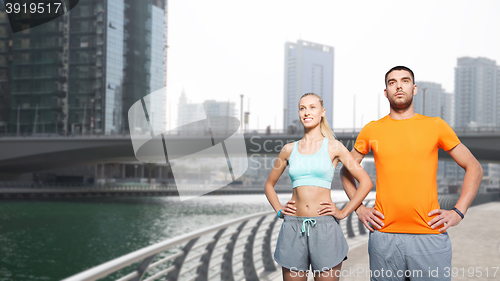 Image of couple exercising over dubai city street 