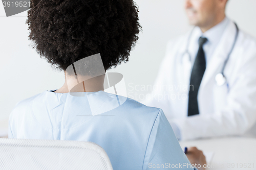 Image of close up of african doctor at hospital from back