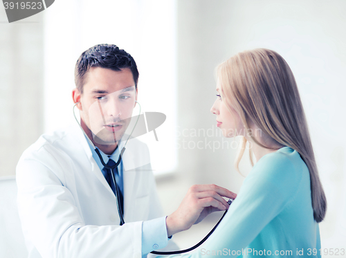 Image of doctor with stethoscope listening to the patient