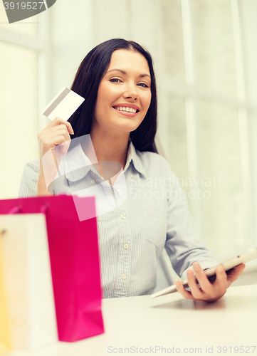 Image of smiling woman with blank screen tablet pc