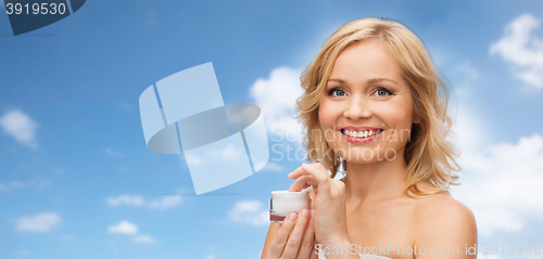 Image of happy woman with cream jar