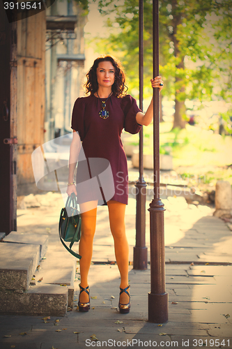 Image of woman in a fashion burgundy dress