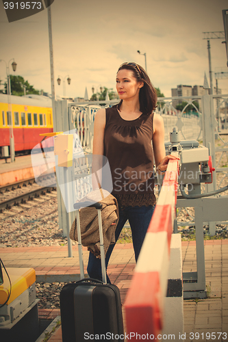 Image of woman with a luggage waiting on the border