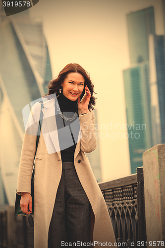 Image of smiling middle-aged woman talking on a mobile phone