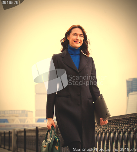 Image of Smiling businesswoman outdoors