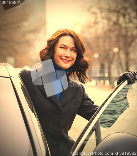 Image of woman sits in the car