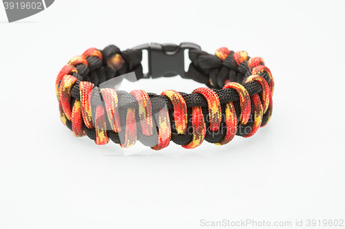 Image of black and orange braided bracelet on white background