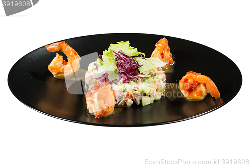 Image of perfect dish with shrimps on a black plate. seafood. Isolated  white background