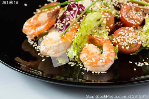 Image of perfect dish with shrimps on a black plate. seafood