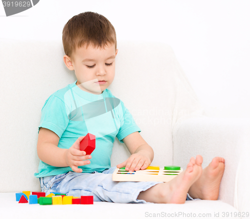 Image of Boy is playing with puzzle