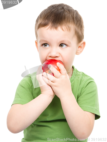 Image of Portrait of a cute little boy with red apple