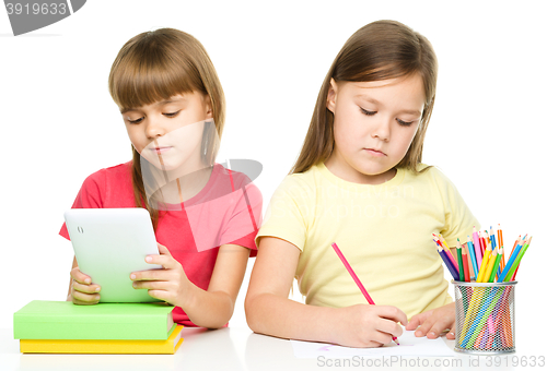 Image of Children with tablet and color pencils