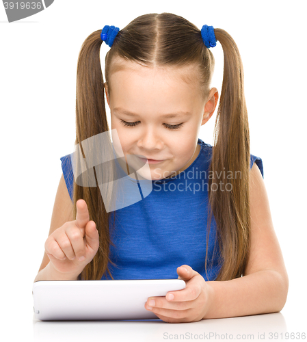 Image of Young girl is using tablet