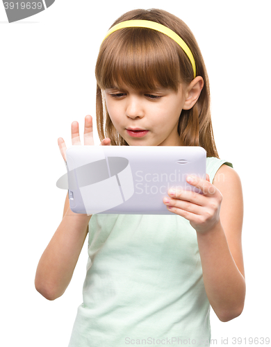 Image of Young nearsighted girl is using tablet