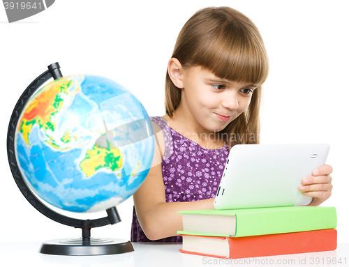 Image of Young girl is using tablet
