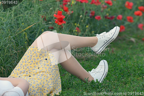 Image of young girl  lying on field