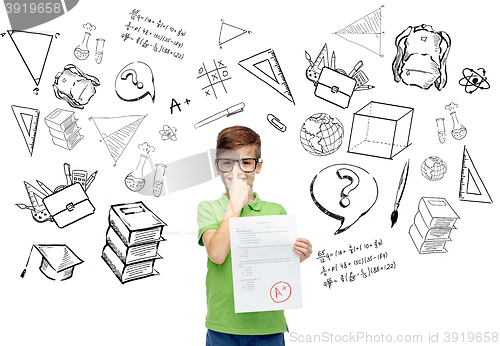 Image of happy boy in eyeglasses holding school test result