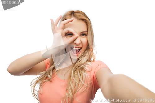 Image of happy smiling young woman taking selfie