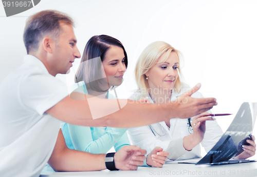 Image of doctor with patients looking at x-ray