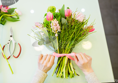 Image of close up of woman making bunch at flower shop