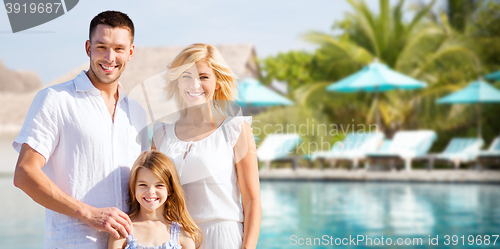 Image of happy family over hotel resort swimming pool