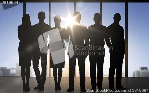 Image of business people silhouettes over office background