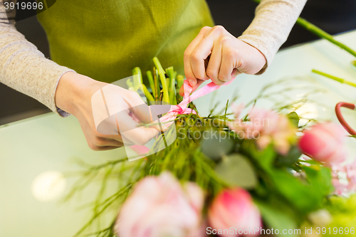 Image of close up of woman making bunch at flower shop