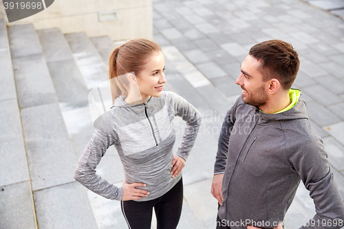 Image of smiling couple outdoors on city street