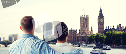 Image of close up of male gay couple hugging over big ben