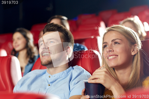 Image of happy friends watching movie in theater