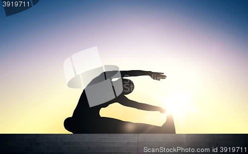 Image of woman doing exercises on stairs over sun light