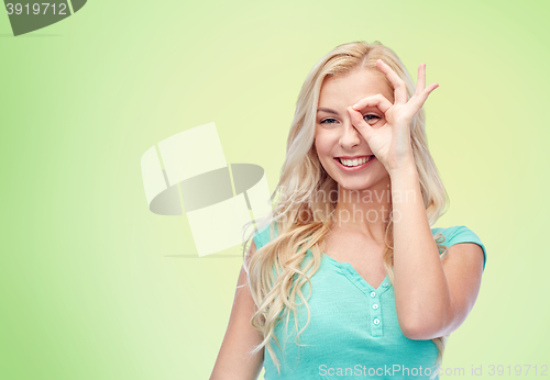 Image of young woman making ok hand gesture