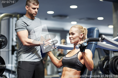 Image of man and woman flexing muscles on gym machine