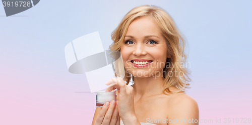 Image of happy woman with cream jar