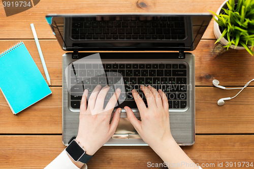 Image of close up of woman or student typing on laptop