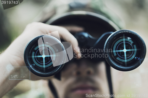 Image of close up of soldier or hunter with binocular