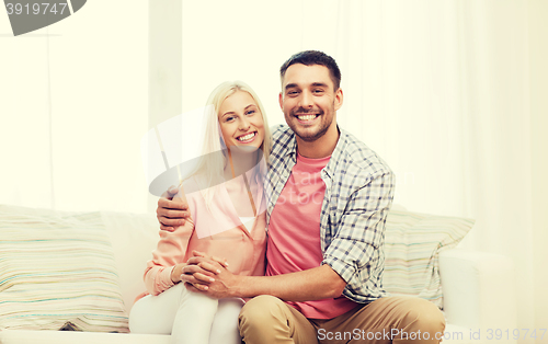 Image of smiling happy couple at home