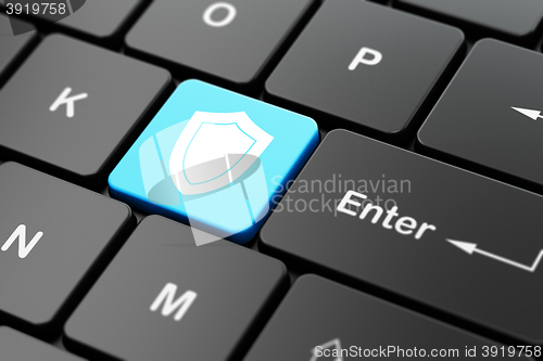 Image of Privacy concept: Shield on computer keyboard background
