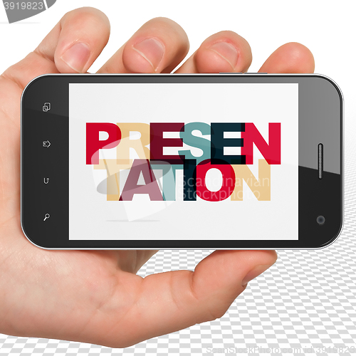 Image of Advertising concept: Hand Holding Smartphone with Presentation on  display