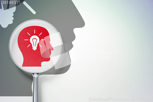 Image of Finance concept:  Head With Light Bulb with optical glass on digital background