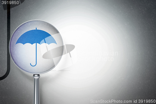 Image of Security concept:  Umbrella with optical glass on digital background