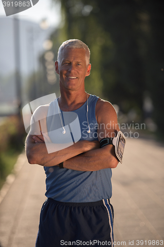 Image of portrait of handsome senior jogging man